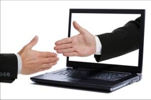 shaking hands over computer