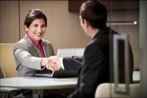 man and woman shaking hands sitting down